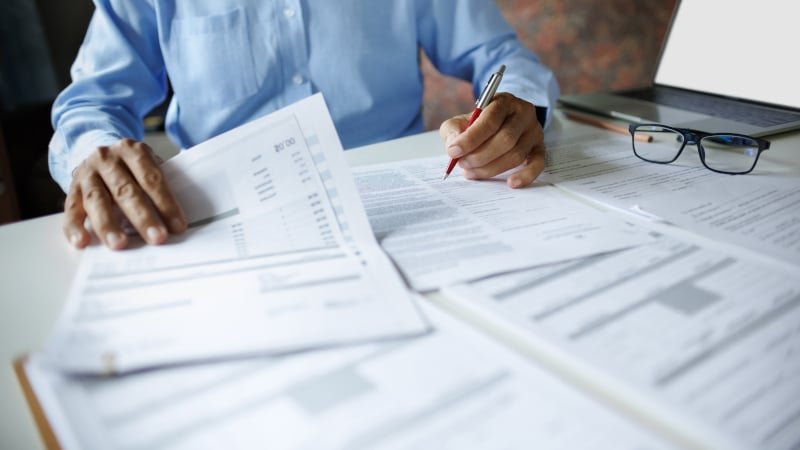 Professional reviewing financial settlement documents for divorce proceedings