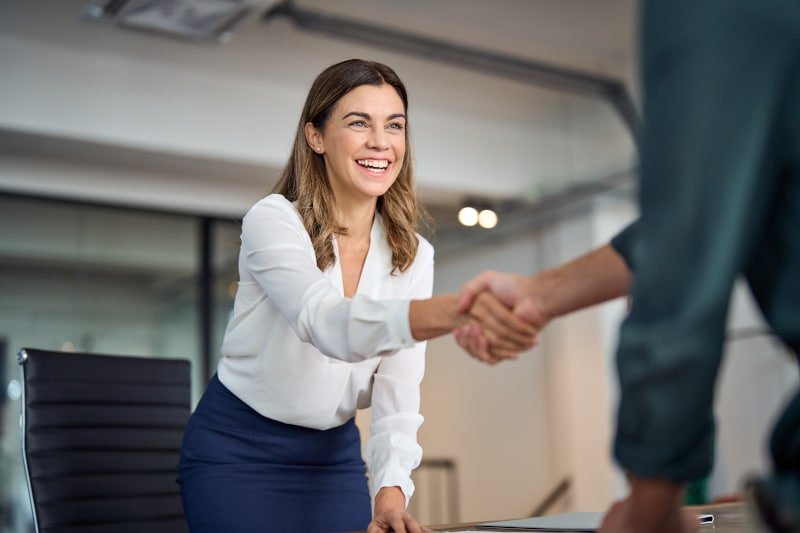 Professional handshake representing successful coordination between solicitor, client and lender in commercial re-financing
