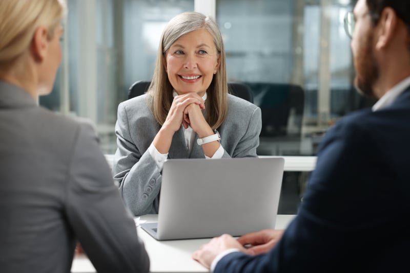 Business professionals discussing commercial property purchase with legal advisor